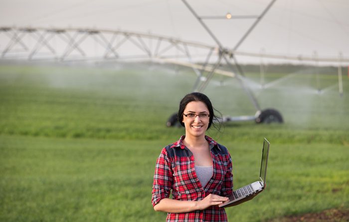 Farmer and irrigation equipment in field